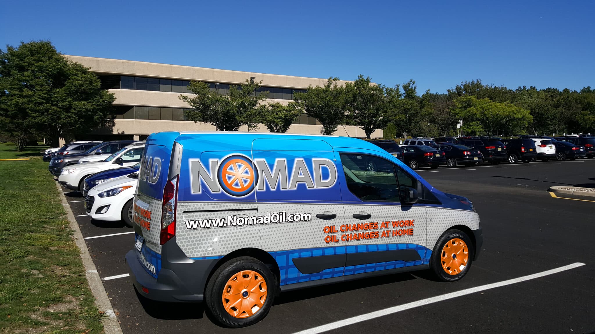 MOMS Mobile Oil Change van in a suburban driveway