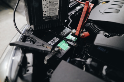 Technician replacing a vehicle battery