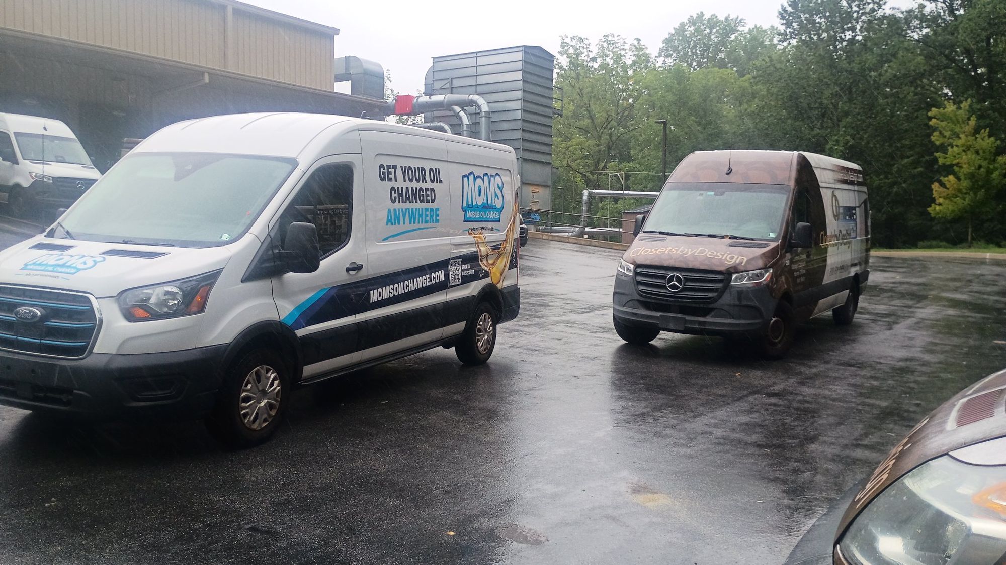 The MOMS Transit van beside a customer's fleet van at their lot.