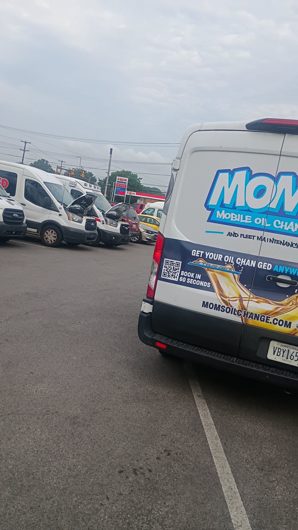 The MOMS Transit van at a fleet lot with company vans lined up behind it.