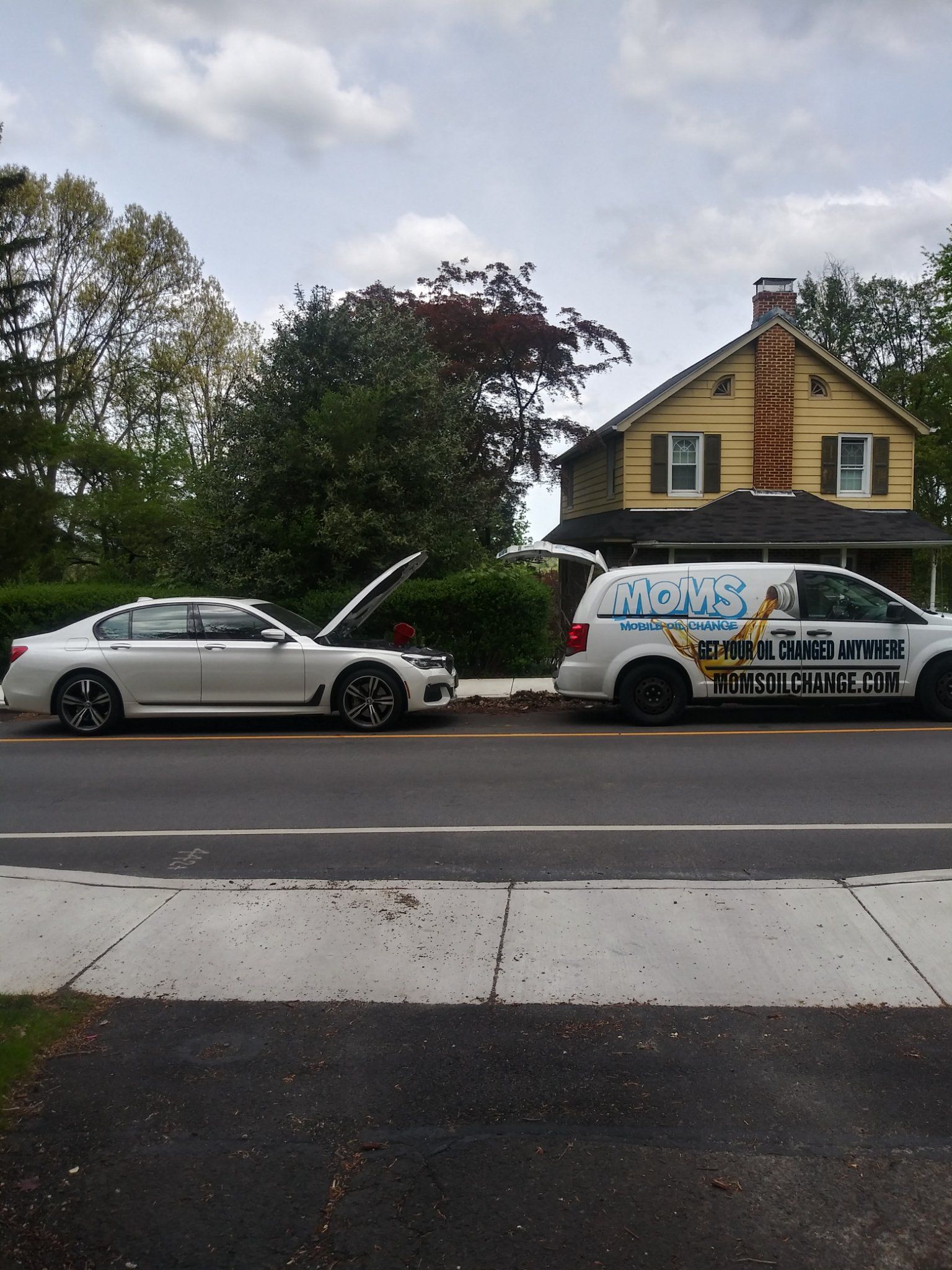 Full synthetic oil change on a BMW in a customer's driveway.